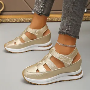 Side view of women's gold wedge sandals with closed-toe hollow design and velcro straps.