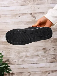 Detailed macro view showing the textured non-slip rubber sole of a black platform shoe