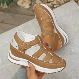 Close-up of tan closed-toe wedge sandals with breathable hollow-out design