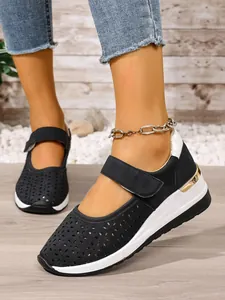 Close-up of black breathable hollow-out platform sneakers featuring stylish Velcro strap