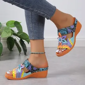 Stylish women's ethnic wedge sandals featuring colorful floral patchwork and a comfy orange sole