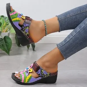 Close-up of bohemian style colorful wedge sandals worn with jeans and an anklet