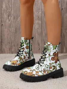 Detailed view of floral print combat boots with a white base and black lace-up front styling.