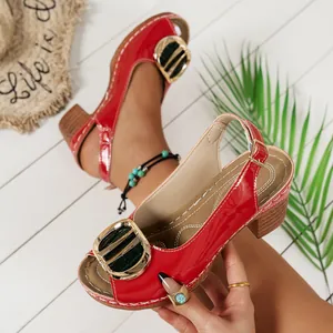 Detailed view of red high-heel peep-toe sandals with decorative buckle detail