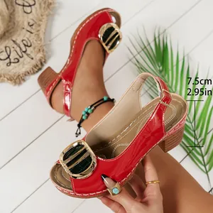 Close-up of red patent leather high-heeled sandals showing 7.5cm heel height and gold buckle