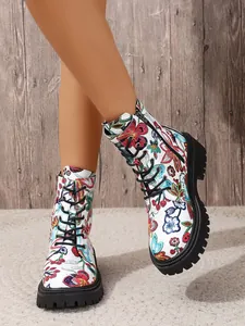 Detailed shot of white floral embroidered combat boots with thick lug soles