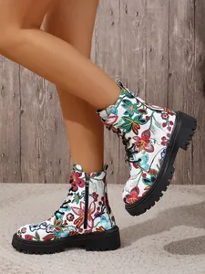 Close-up of women's floral print ankle boots with thick soles and lace-up design