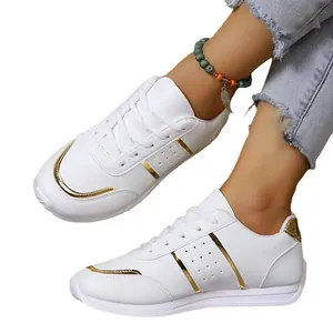Stylish white leather sports sneakers for women with elegant gold accents