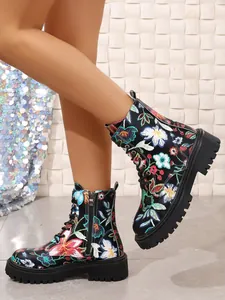 Floral print combat boots with chunky soles and lace-up design in a side-view detail.
