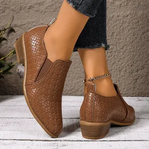 Detailed view of stylish brown woven leather pointed-toe women's shoes with chunky heels