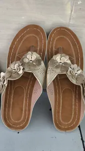 Women's gold floral thong sandals with stitched footbed for casual beach vacation