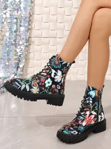 Detailed view of women's floral print combat boots with lace-up and lug sole design