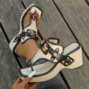 Close-up of bohemian wedge thong sandals with woven texture and leopard buttons
