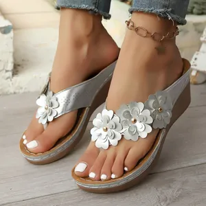 Elegant silver wedge sandals with 3D white flower accents for stylish beach vacations