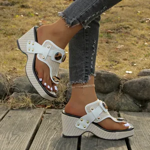 Close-up detail of women's straw wedge thong sandals featuring leopard print accent buttons.