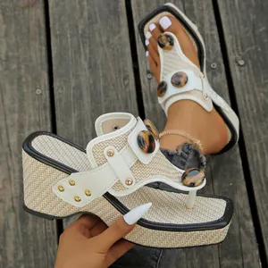 Wedge flip-flop sandals with woven straw texture and leopard print buckle detail.