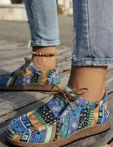 Close-up of women's ethnic canvas shoes with colorful graffiti patterns and laces