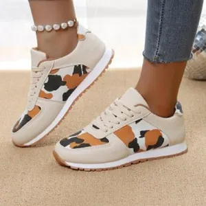 Women's leopard print casual sneakers with lace-up design and white sole detail.