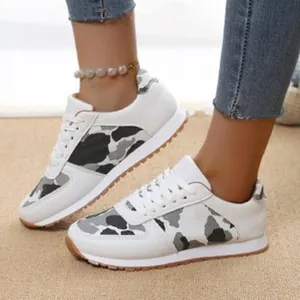 Detailed view of women's leopard print casual sneakers with white lace-up design