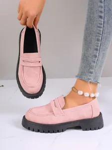 Pink suede platform loafers for women with thick black lug soles and slip-on design