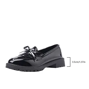 Detail shot of black patent leather loafers showing 3.5cm chunky heel height