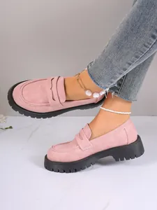 Side view of stylish pink suede loafers featuring chunky black platform lug soles