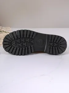 Close-up of durable black lug sole with size mark 235 on chunky loafer
