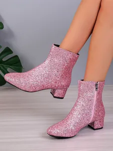 Detailed view of pink glitter chunky heel ankle boots with a convenient side zipper