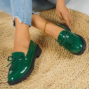 Premium stylish dark green patent leather loafers with decorative tassels and chic bow detail