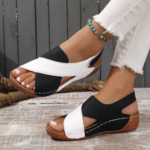 Close-up of stylish black and white wedge sandals with hollow-out open-toe design