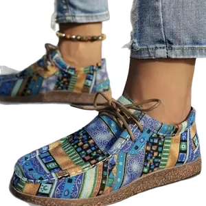 Women's ethnic style colorful graffiti canvas shoes with lace-up cork platform soles.