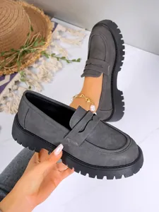 Close-up of grey British style platform loafers with thick non-slip soles