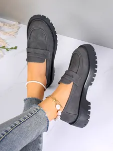 Grey suede platform loafers with chunky lug soles for a stylish British academic look