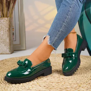Elegant dark green patent leather loafers with bow detail and chunky sole for women