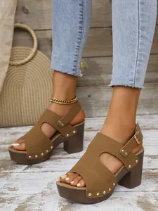 Zijaanzicht van bruine suède platform sandalen met klinknagels en riempje