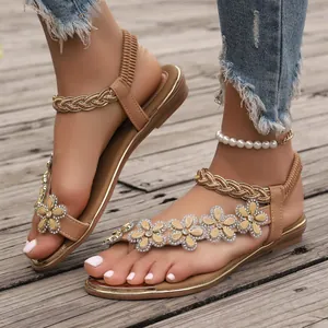 Elegant tan summer flat sandals for women featuring rhinestone flower embellishments.