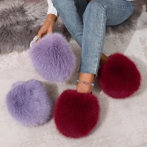 Close-up detail of plush fluffy faux fur slippers in purple and burgundy colors