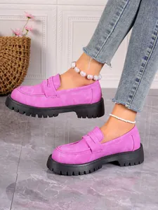 Vibrant pink platform loafers with thick soles shown on feet for styling