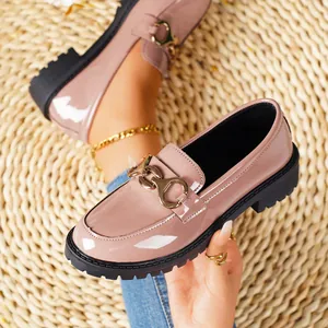 Elegant glossy pink patent leather loafers with thick black lug sole and gold hardware