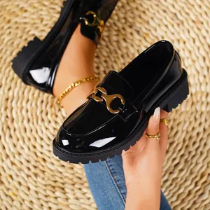 Black patent leather loafers with gold buckle detail and chunky sole for women