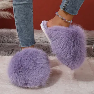 Detail view showing the soft texture of fluffy purple faux fur slippers for women