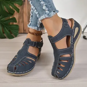 Women's casual navy blue closed-toe wedge sandals with white contrast stitching and velcro