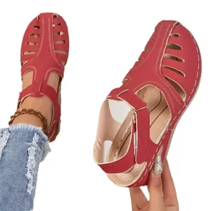 Red closed toe wedge sandals for women with hollow-out design and velcro straps.