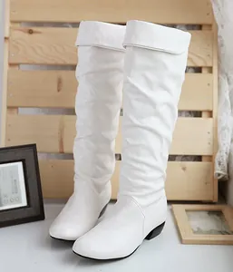 Detailed view of white slouchy high-top boots with black low heels and a folded cuff.