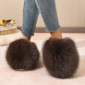 Close-up of fluffy brown faux fur slippers showing the soft, voluminous texture.