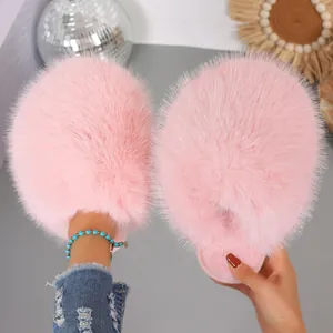 Detailed macro view of plush pink faux fur slippers showing soft and fluffy texture
