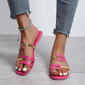 Stylish pink and gold flat sandals for women, perfect for summer casual wear at the beach.