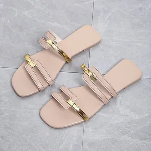 Top view detail of stylish pink flat slide sandals with metallic gold straps
