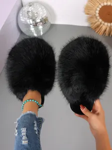 Detailed view of black fluffy faux fur house slippers with soft plush texture and cozy design