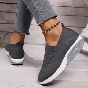 Detailed view of women's dark grey fly-knit rocker sneakers with a thick air cushion sole